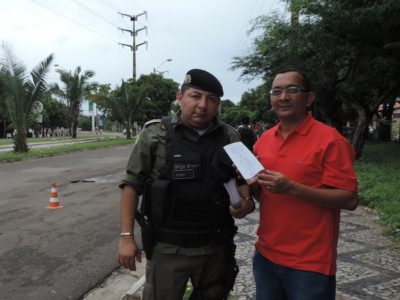 O Promotor de Justiça Francisco de Jesus Lima (à direita) ao lado do Cap. Fábio Soares, que comandou a operação. Os dois exibem folheto educativo do NUPEVID.