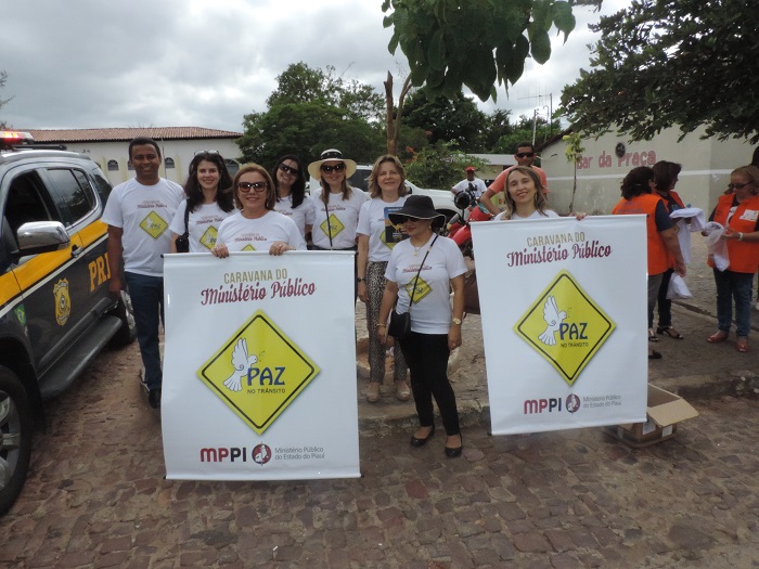 Pessoas segurando faixas da caravana do MP
