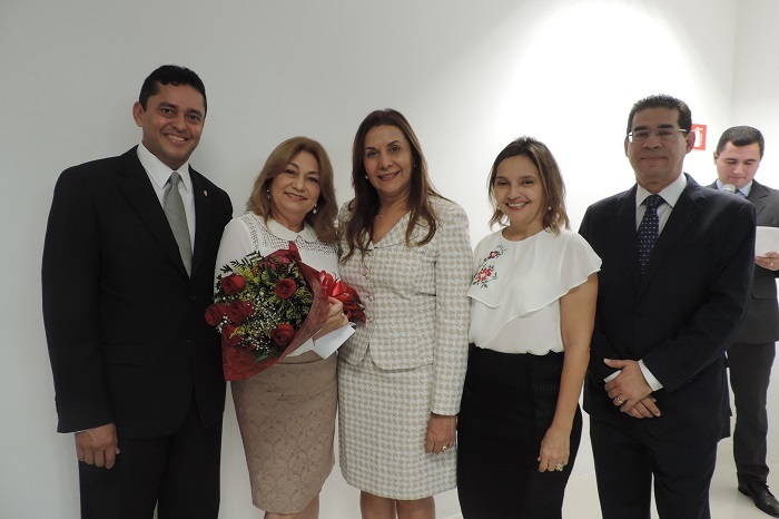 Pessoas de pé sorrindo para foto