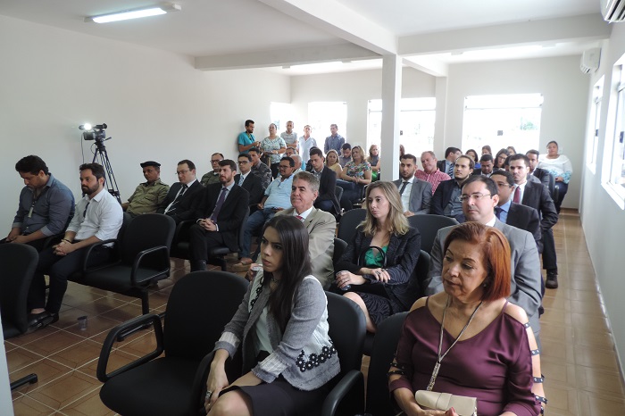Pessoas sentadas num auditório assistindo uma cerimônia
