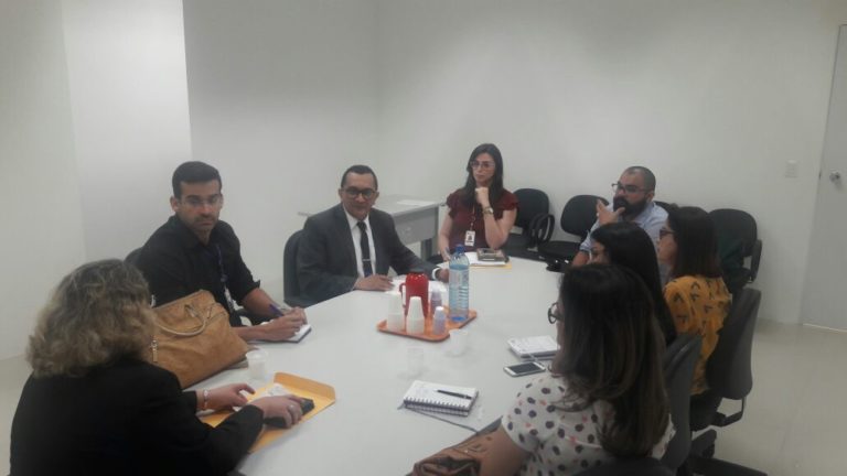 Pesssoas reunidas em torno de uma mesa.