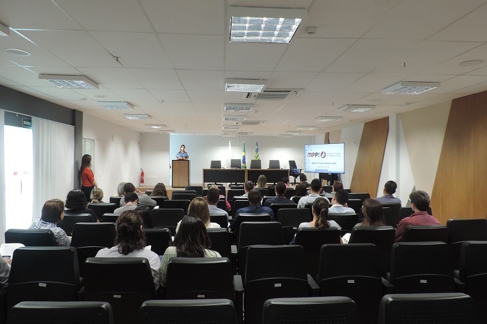 Pessoas sentadas em auditório 