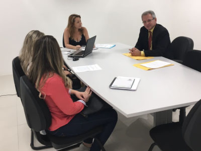 Quatro pessoas em torno de uma mesa de reuniões.