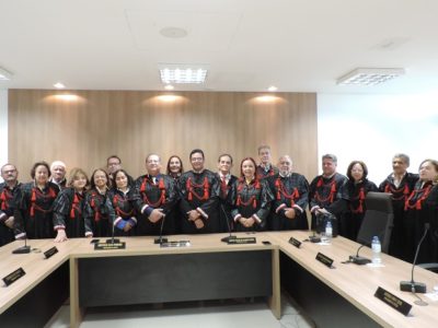 Colégio de Procuradores de Justiça posa de pé. Cerca de vinte pessoas trajando becas