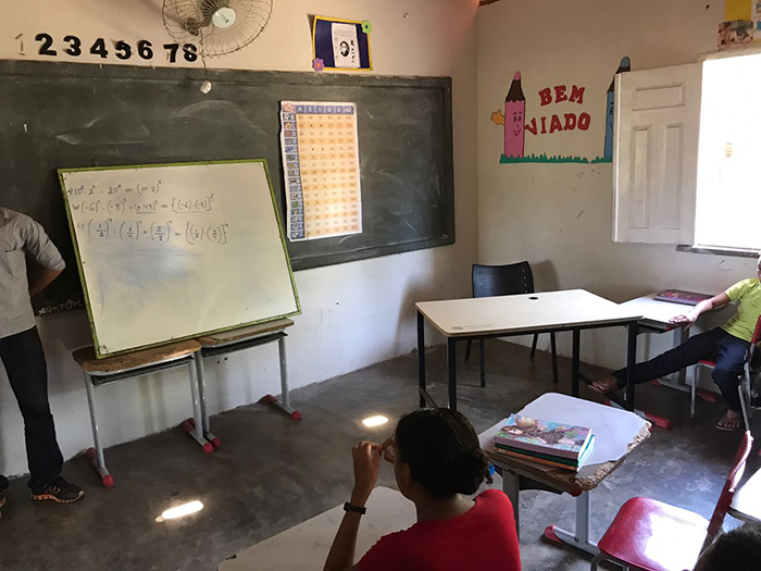 Sala de aula. Alunos de costas, voltados para o quadro