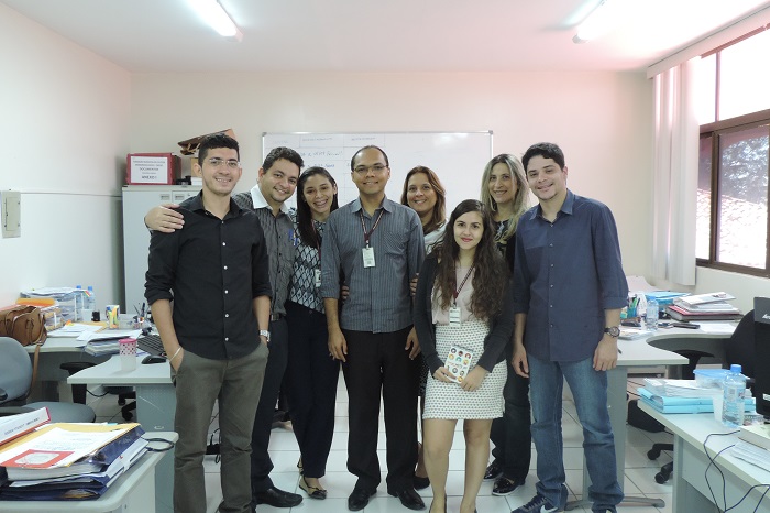 Pessoas de pé sorrindo para fotografia