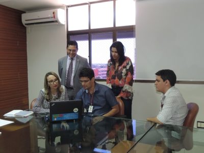 Pessoas de pé olhando para o computador