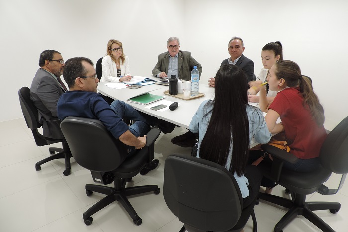 Pessoas dentadas em torno de uma mesa conversando