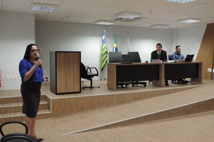 Mulher de pé com microfone na mão 