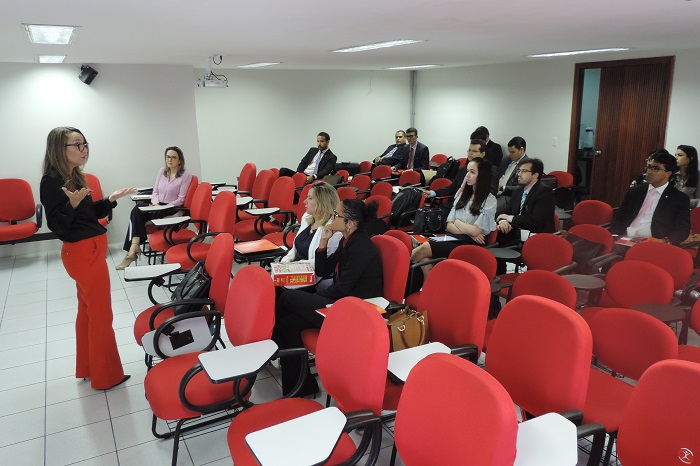 Promotora fala aos juízes em um auditório