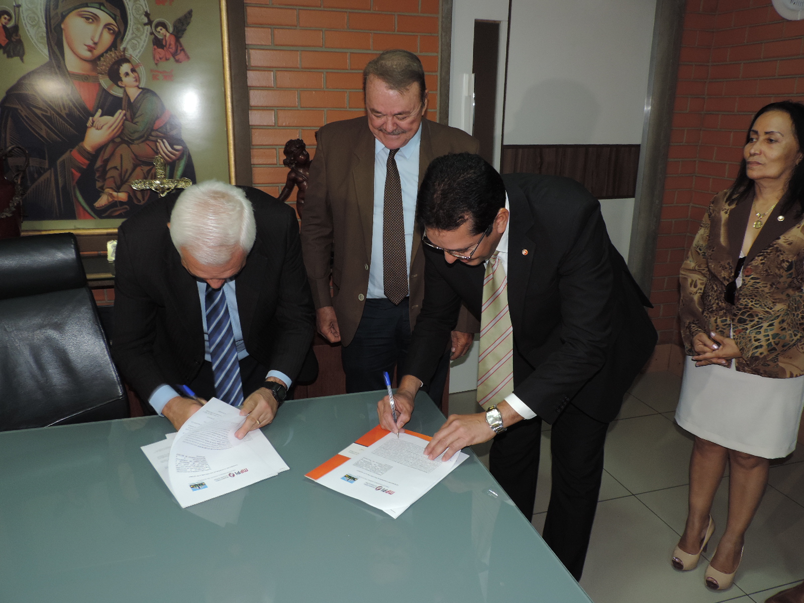 Duas pessoas assinando documentos 