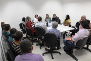 Pessoas sentadas em volta de uma mesa