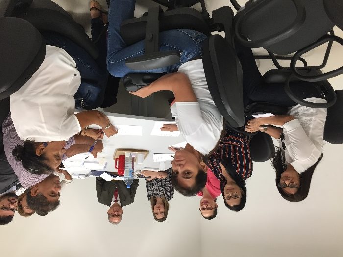 Pessoas sentadas em volta de uma mesa