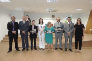 Pessoas sorrindo e posando com troféus