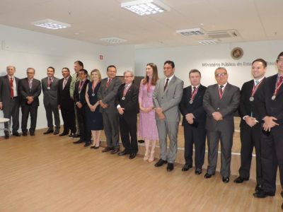 Pessoas posando e sorrindo com medalhas ao pescoço