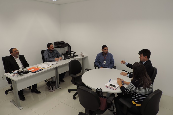 Pessoas sentadas em volta de uma mesa