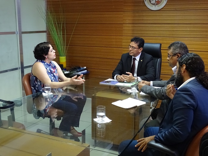 Pessoas sentadas em volta de uma mesa 
