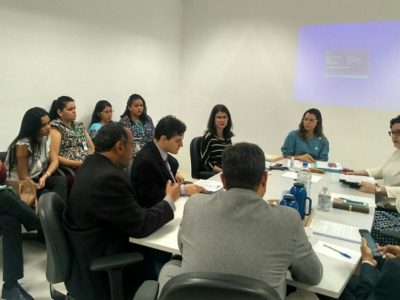 Pessoas sentadas em volta de uma mesa