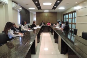 Pessoas sentadas em volta de uma bancada