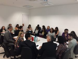 Pessoas sentadas em volta de uma mesa