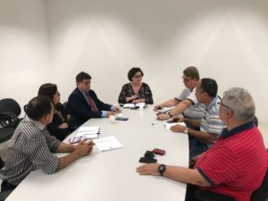 Pessoas sentadas em volta de uma mesa