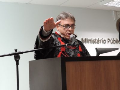 Homem de pé com a mão estendida falando