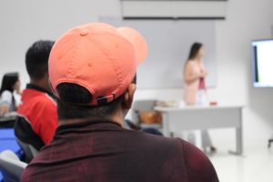 Foto de um homem assistindo uma palestra