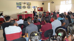 Promotor palestrando diante de auditório lotado