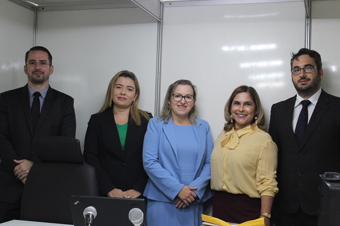 Quatro pessoas de pé sorrindo
