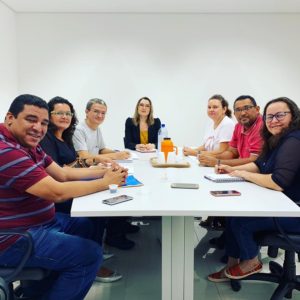 Pessoas sentadas em volta de uma mesa