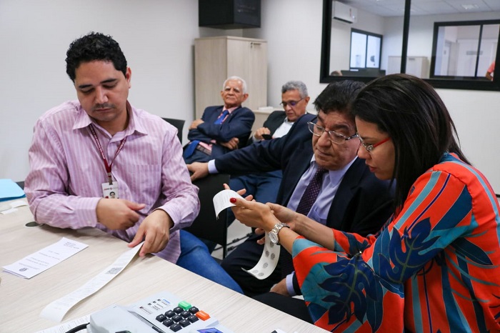 Pessoas sentadas olhando para papel 