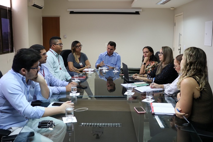 Pessoas reunidas em volta de uma mesa durante reunião