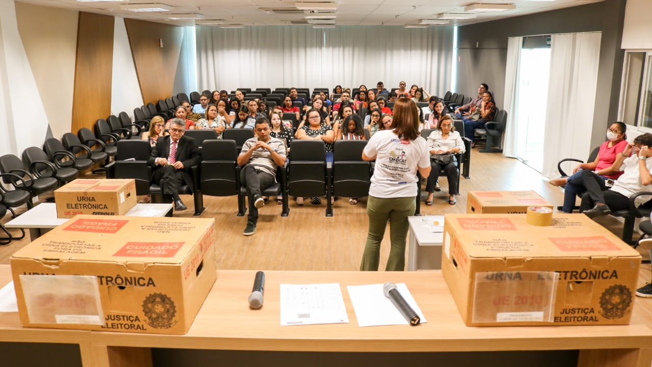 Pessoas sentadas em auditório 