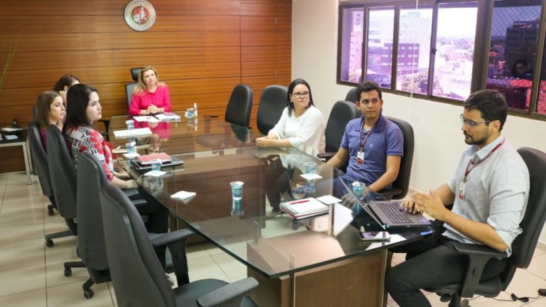 Pessoas sentadas em volta de uma mesa