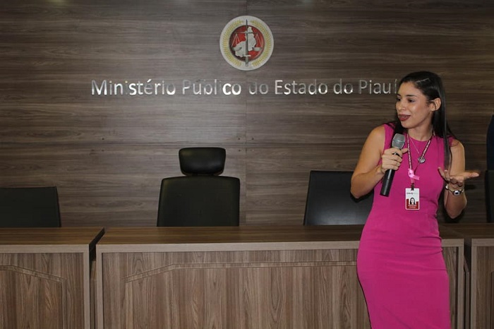 Mulher falando para plateia de auditório 