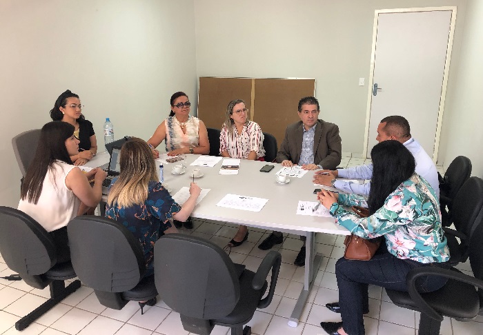 Pessoas sentadas em volta de uma mesa