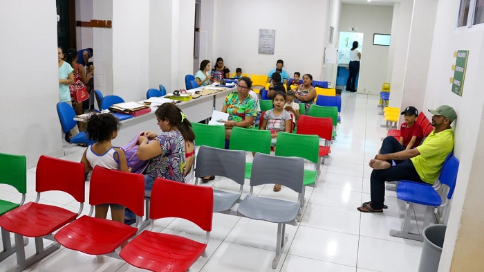 Pessoas sentadas na área de atendimento do hospital 