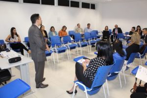 Pessoas reunidas em círculo escutando homem falando