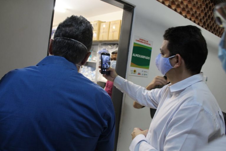 Homem fazendo registro fotográfico de espaço no hospital de campanha